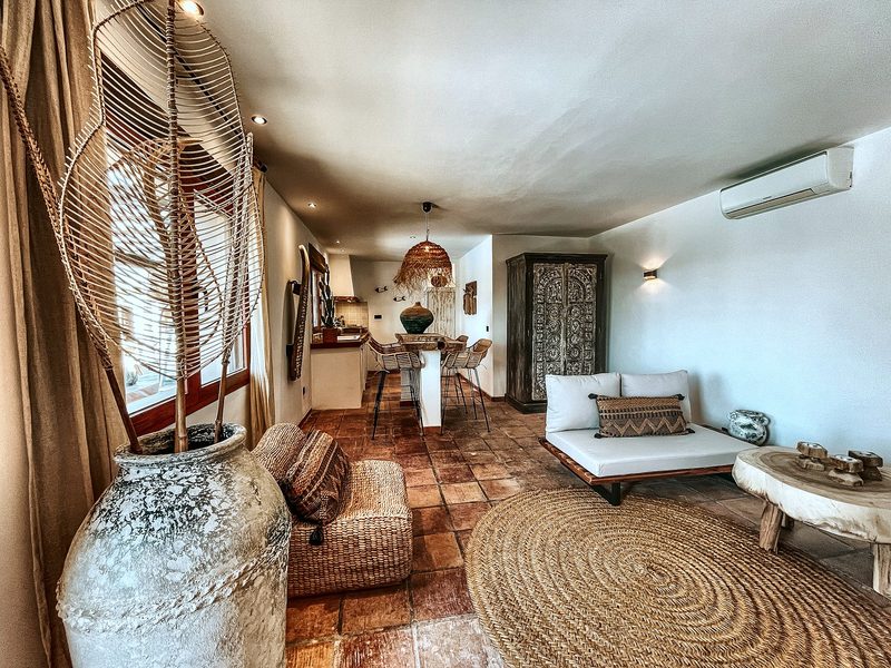 De zithoek van Appartement Jasmin, met jute vloerkleed en zachte tinten